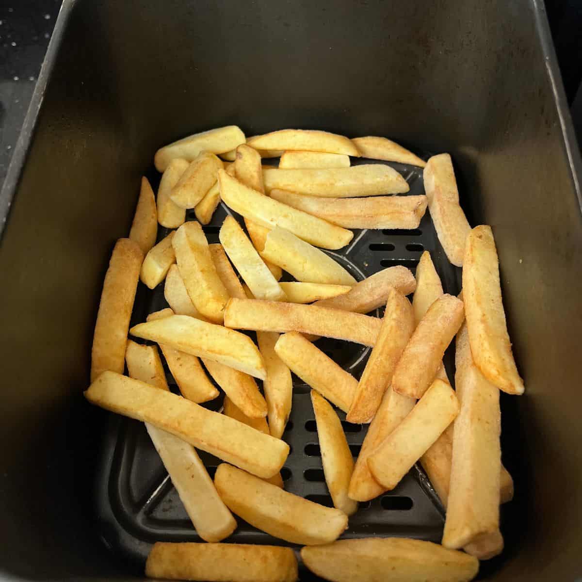 Oven chips in an air fryer basket.