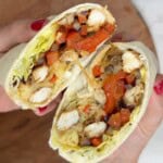 Someone holding a chicken fajita wrap.