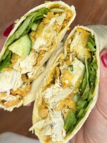 Someone holding an open chicken katsu wrap.