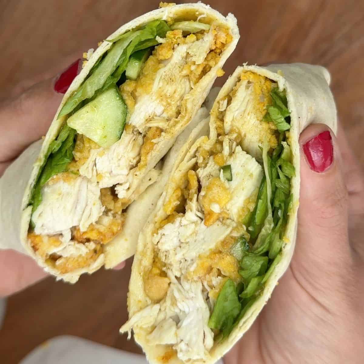 Someone holding an open chicken katsu wrap.
