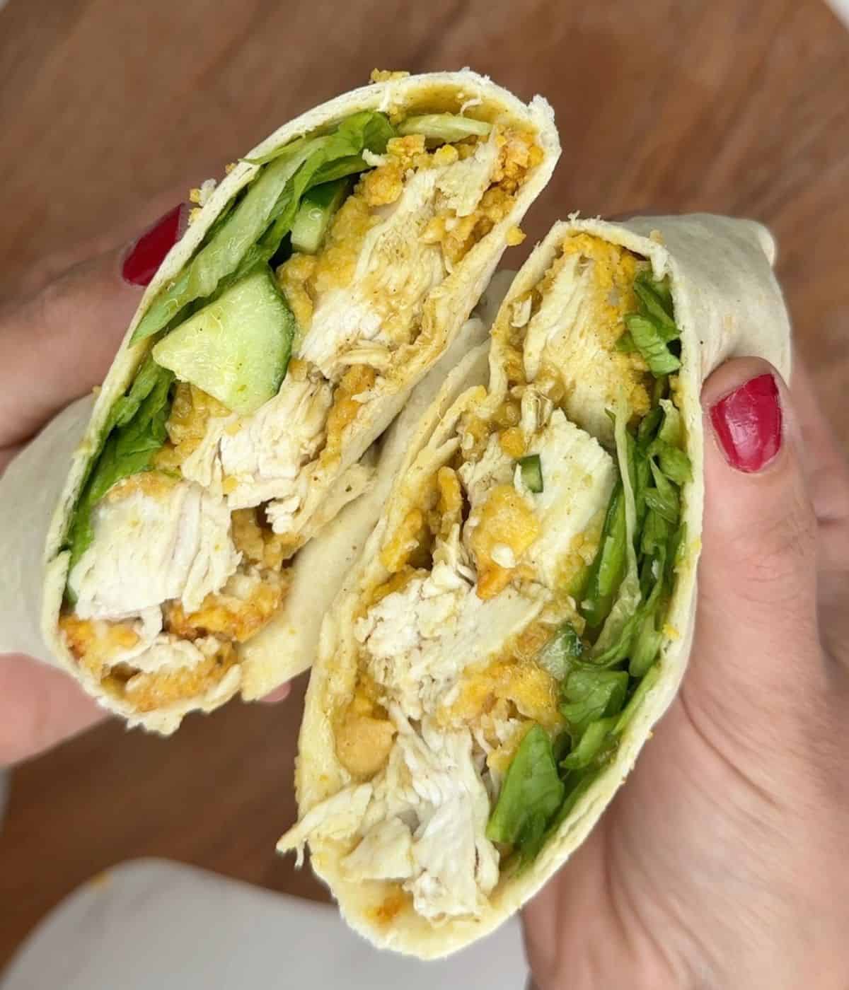 Someone holding an open chicken katsu wrap.