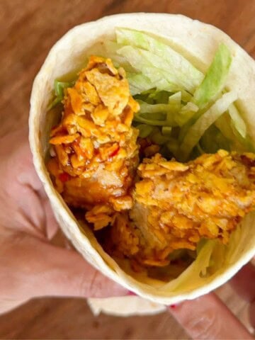 Crispy chicken wrap with iceberg lettuce.