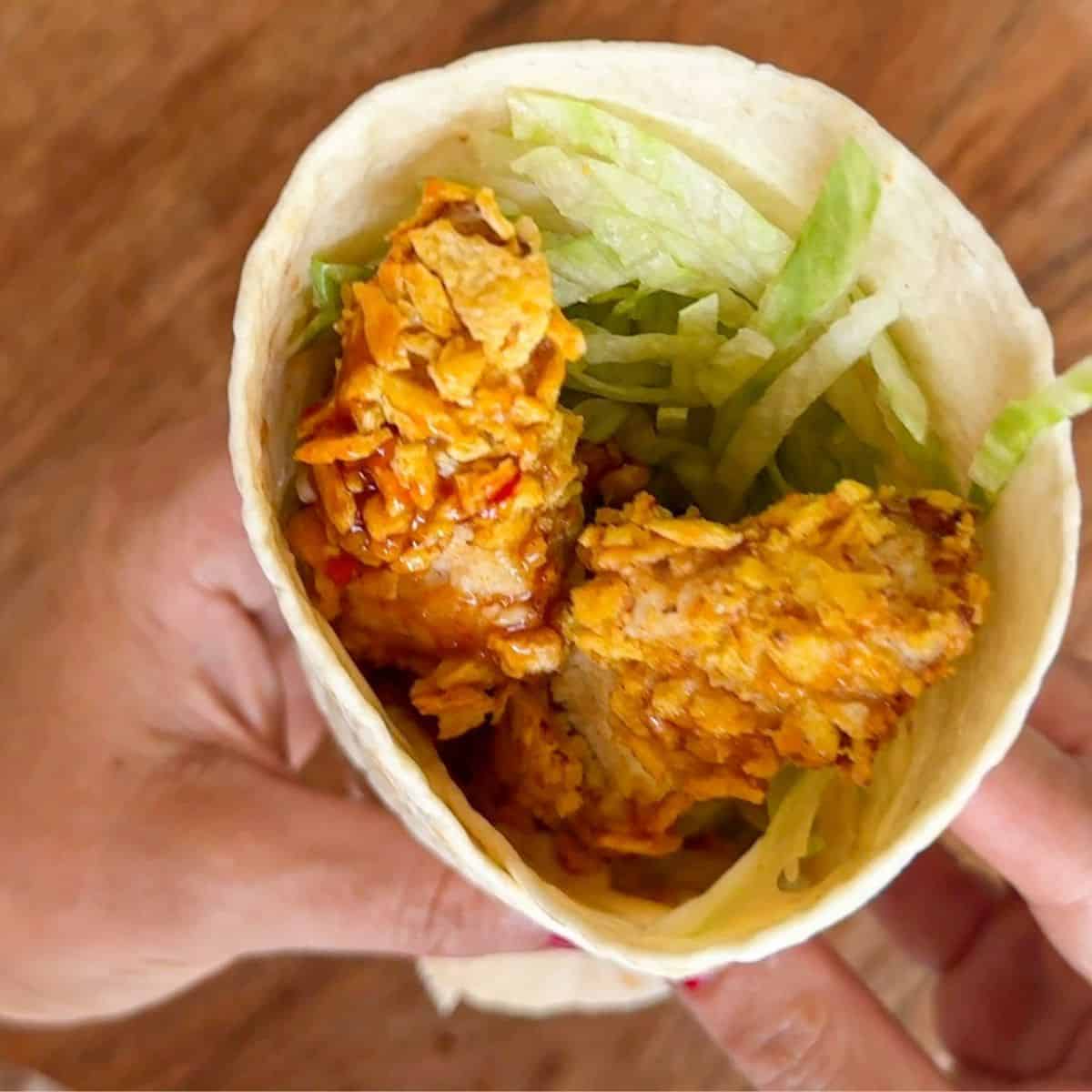 Crispy chicken wrap with iceberg lettuce.