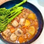 A bowl of sausage casserole and tenderstem broccoli.
