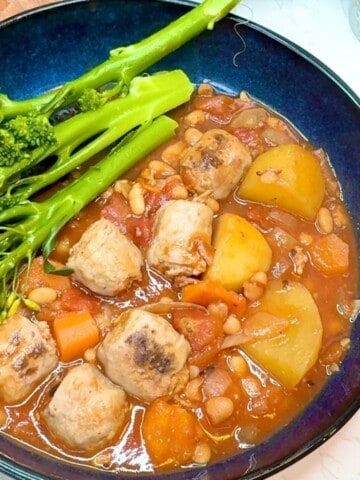 A bowl of sausage casserole and tenderstem broccoli.