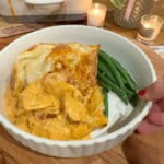 A bowl of marry me chicken pie and green beans.