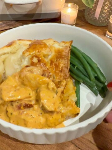 A bowl of marry me chicken pie and green beans.