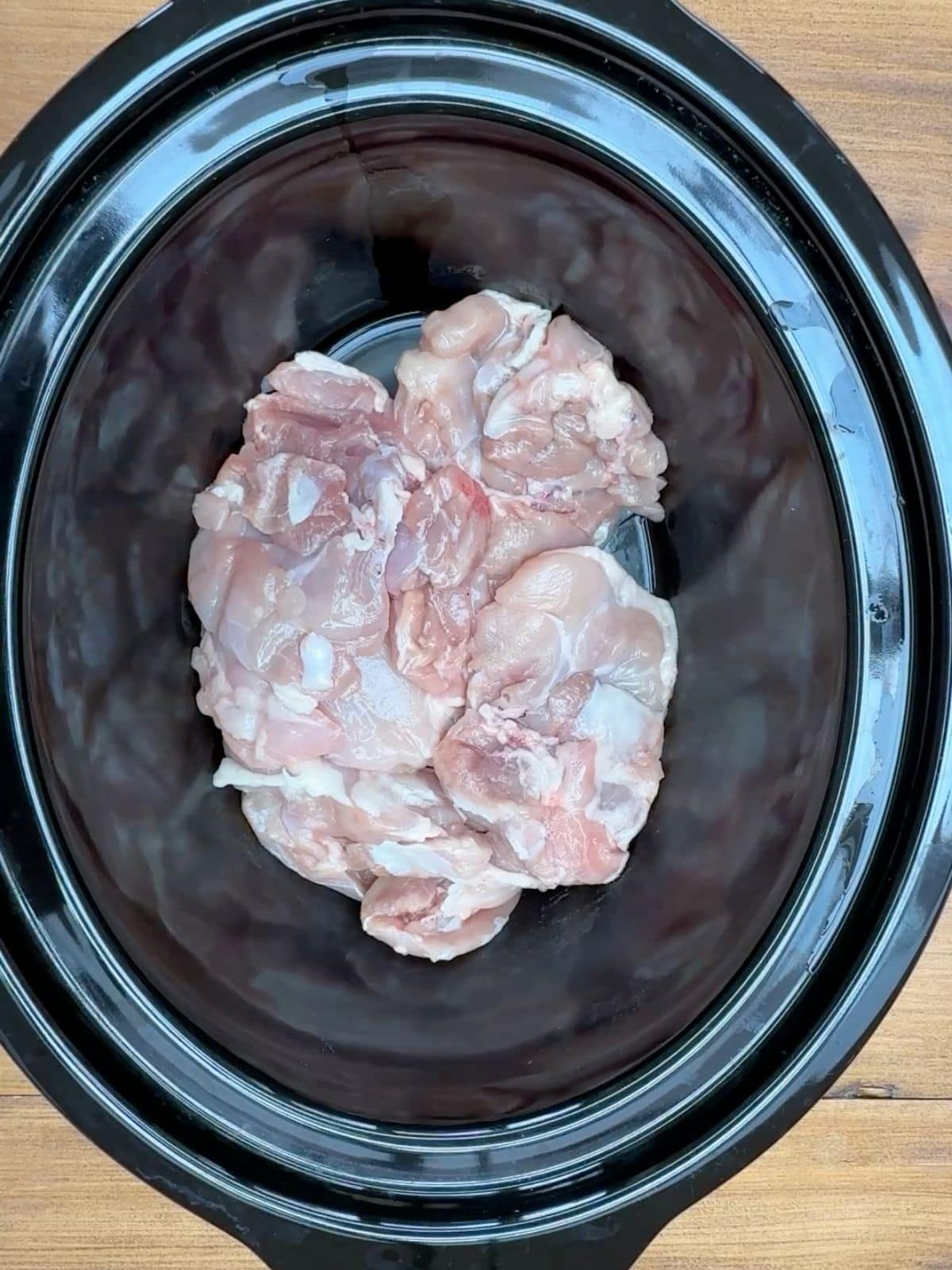Raw chicken in a slow cooker.