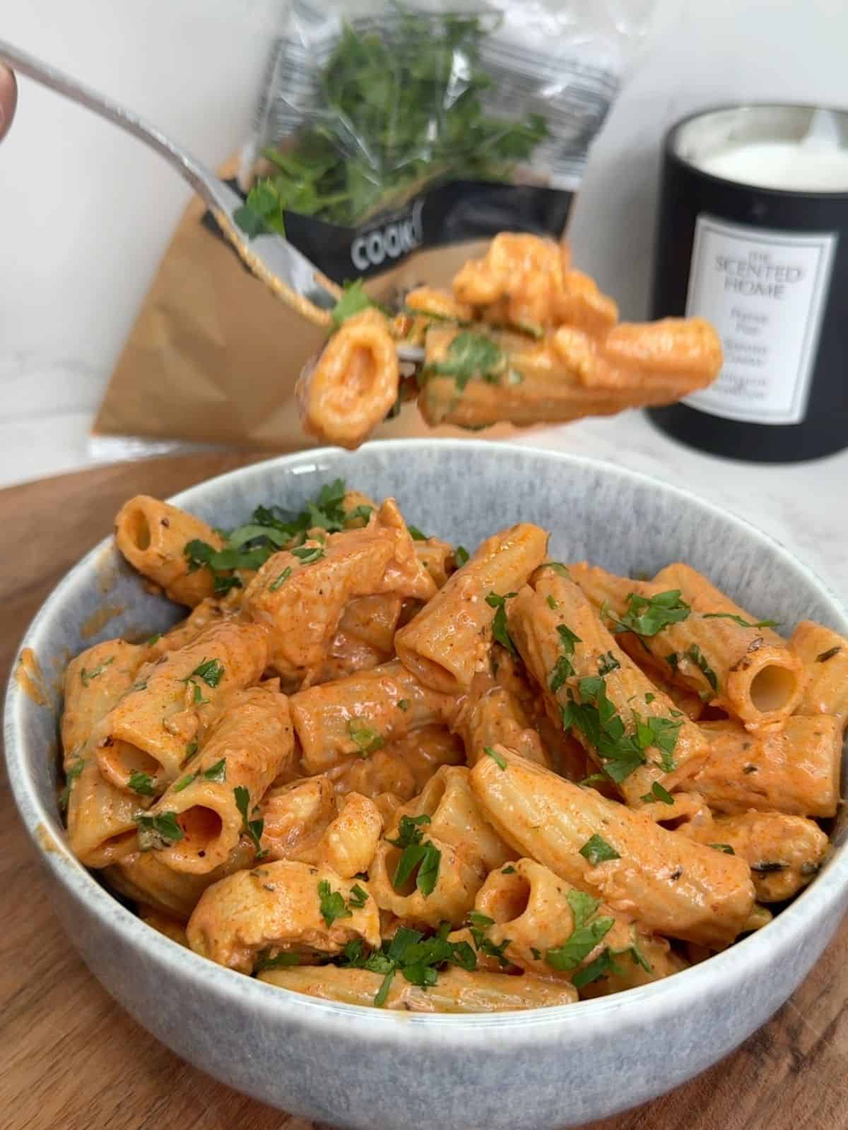A bowl of chicken and halloumi pasta.