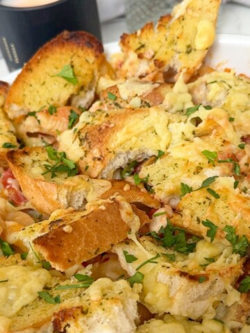 Garlic bread with cheese topped pasta bake.